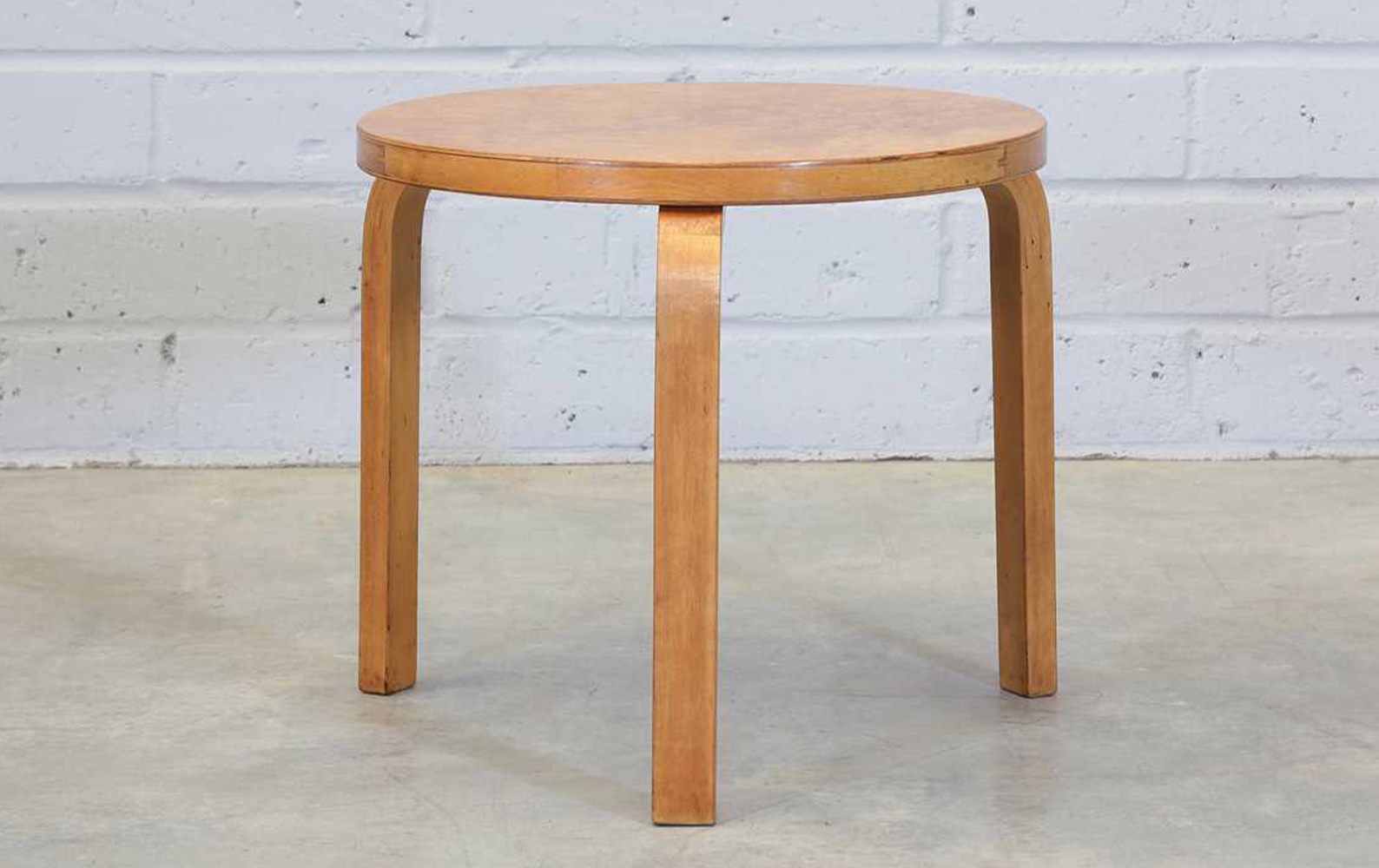 A Finnish masur birch and bentwood side table, late 1930s, designed by Alvar Aalto (Sold for £1,950)